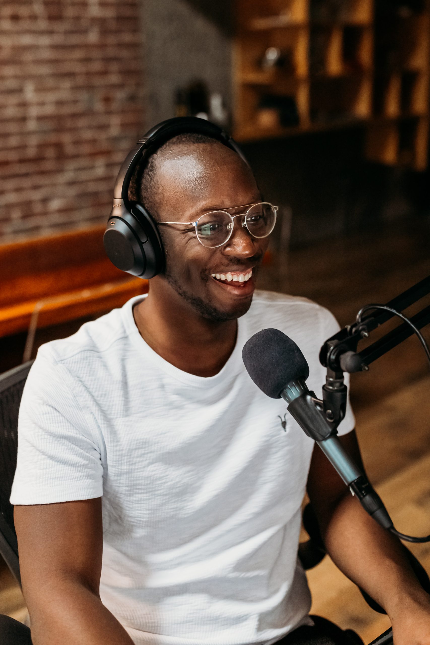 Podcaster smiling at a microphone